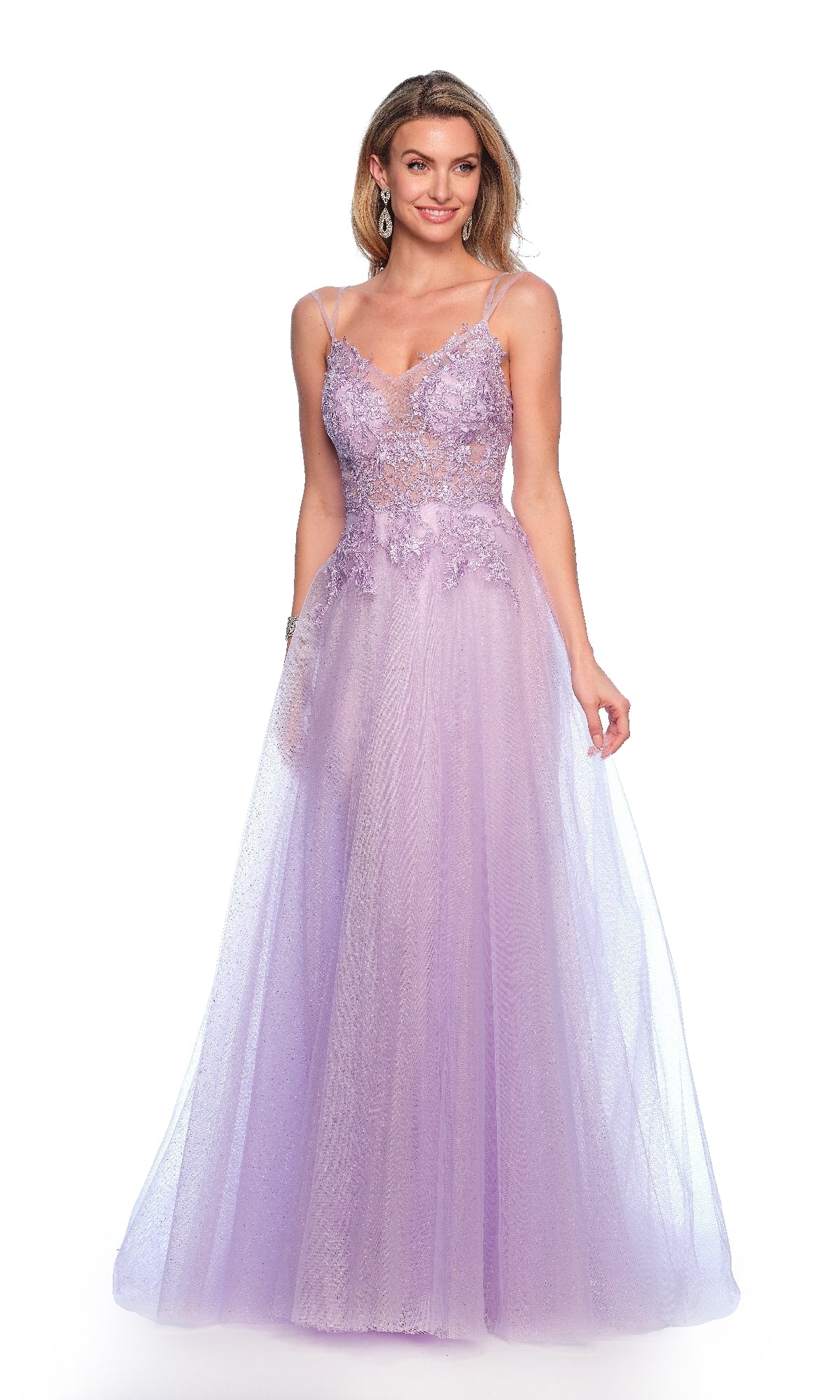 A woman stands against a white background wearing the Long Lilac Prom Dress: Dave & Johnny 11686, featuring delicate lace, tulle fabric, thin straps, floral embellishments, and a fitted bodice.